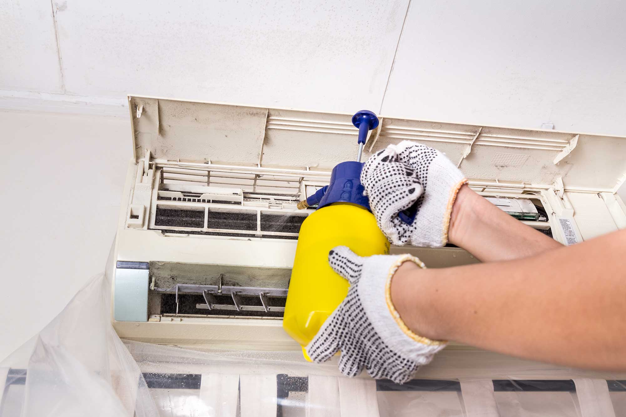 technician-spraying-chemical-water-onto-air-condit-2021-09-01-22-05-03-utc